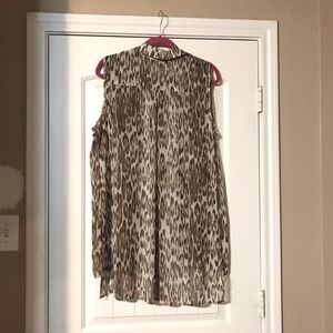 This a flowing blouse that can worn as a top or can be left with cute tank.